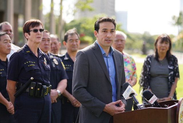 Rep Chris Lee speaks with support from HPD Chief Susan Ballard along with first responders from the police department and Honolulu Emergency Medical Services ask state lawmakers to pass four key gun violence prevention bills that would have prevented the Hibiscus Drive shootings near the Capitol.