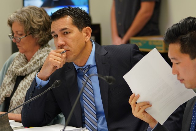 Senator Kai Kahele listens to Chair Stanley Chang during a housing meeting held in the Capitol, room 225.