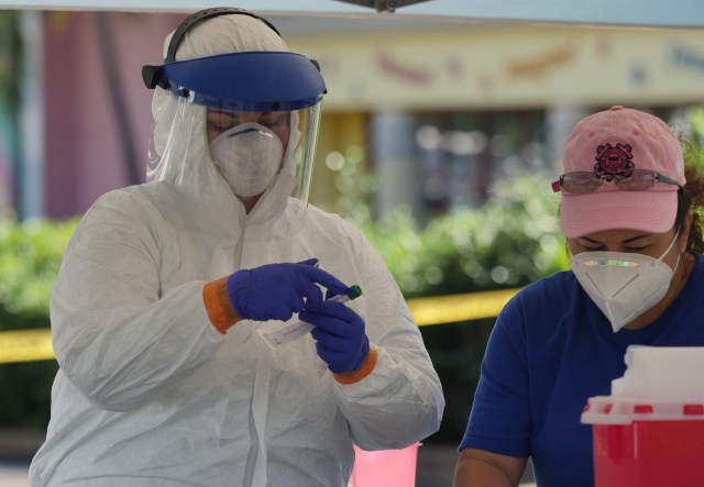 Medical personel seal COVID-19 swab samples into test tubes from the drive through test site at the Kaka'ako Waterfront Park, in Honolulu, HI, Sunday, March 29, 2020. (Ronen Zilberman photo Civil Beat)