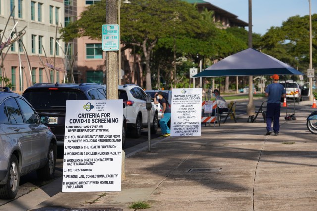 Lists of criteria are outlined on boards placed along Ilalo Street for Coronavirus screening.