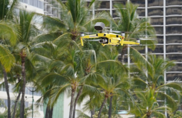 Honolulu Fire Department drone flies over Waikiki Beach notifying people on beach with a small speaker. April 10, 2020.