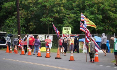 Demonstrators walk in front of the entrance to Sherwood Forest, Waiamanalo. April 6, 2020.