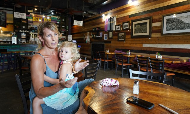 The Beet Box Cafe Haleiwa owner Marlys Mentz with her 4-year-old Moorea Mentz on her lap. Friday will be the first day of online and takeout orders. April 28, 2020.