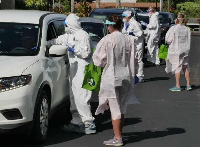 Volunteers from the the COVID Command Mobile Unit, led by Dr. Scott Miscovich, screen Hawaii residents in their cars when they showed up for the free drive through testing event in Wahiwa,HI on Wednesday, April 22, 2020. (Ronen Zilberman photo Civil Beat)