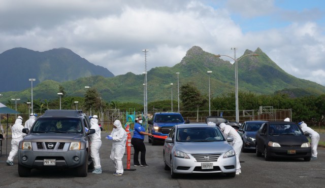 Volunteers from the the COVID Command Mobile Unit, of the Premier Medical Group Hawaii, screen and and perform nose swab tests on Waimanalo residents who came for the free drive through testing event on Sunday, April 26, 2020. (Ronen Zilberman photo Civil Beat)