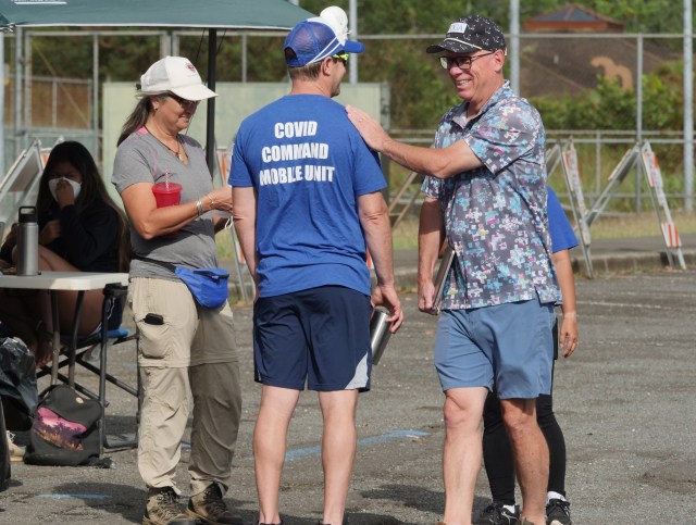 Dr. Scott Miscovich (right) shares a smile with one of his COVID Command Mobile Unit volunteers from the Premier Medical Group Hawaii, during thier free drive through testing event in Waimanalo, HI, Sunday, April 26, 2020. (Ronen Zilberman photo Civil Beat)