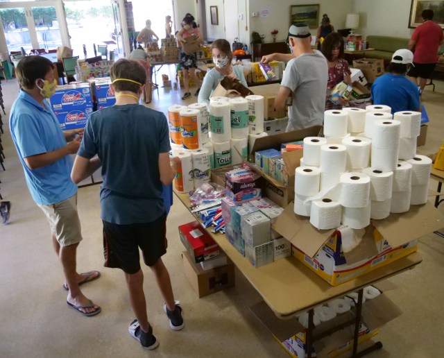 Volunteers sort grocery donations from a food drive at the Central Union Church, in Honolulu, HI, Saturday, May 16, 2020. The Central Union Church partnered up with nonprofit corporatio, Help is on the Way, to collect and deliver food boxes to kupuna and other vulnerable, homebound people on Oahu. They hope to create 200 grocery boxes that will be delivered in the coming week. (Ronen Zilberman photo Civil Beat)