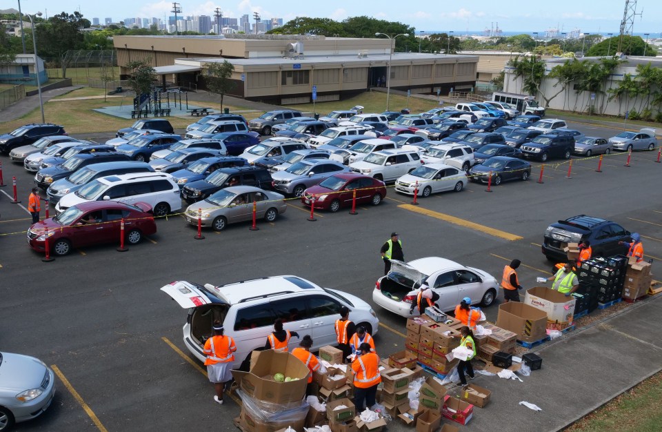 Volunteers from the Lighthouse Outreach Center, a partner agency of the Hawaii Foodbank, handed out food to hundreds of Kalihi residents during an emergency food distribution event in May. 