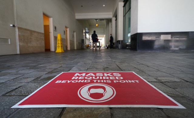 Ala Moana Center perimeter walkway with sign ‘Masks Required beyond this point’ during COVID-19 pandemic. June 24, 2020