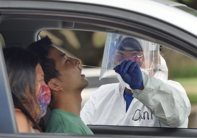 Reese Fujimoto has his nose swabbed for a COVID-19 test at the Waipi'o Peninsula Soccer Complex Saturday, June 27, 2020. Dr. Scott Miskovich continues to lead the Premier Medical Group Hawaiʻi in COVID testing as the State is experiencing a recent rise in positive cases. (Ronen Zilberman photo Civil Beat)