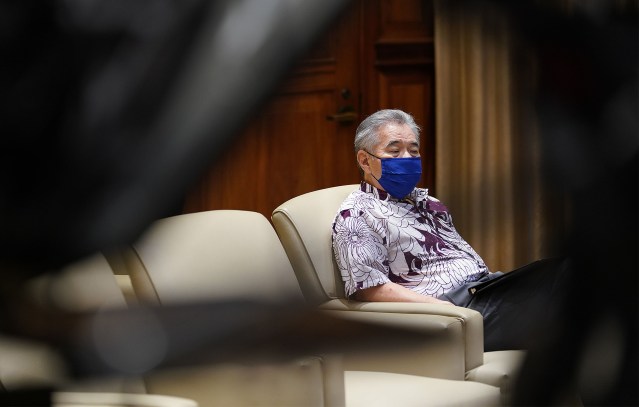 Governor David Ige is seated as Dr. Bruce Anderson speaks during press conference sharing COVID-19 positives and that interisland flights open tomorrow. June 15, 2020