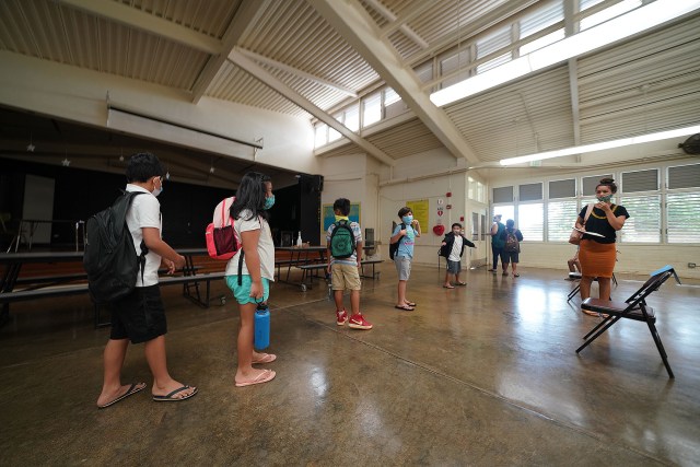 Kaneohe Elementary School summer school kids line up in the cafeteria socially distanced on their way to their classrooms. After arriving to the cafeteria, each child washed their hands and sat on socially disntanced chairs placed 6-feet apart. June 12, 2020