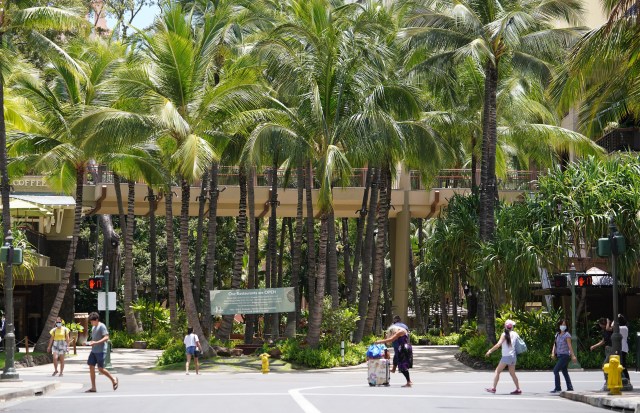 People cross at the intersection of Kalakaua Avenue and Seaside Avenue during COVID-19 pandemic. Transpacific travelers are still required to a 14-day quarantine. June 17, 2020