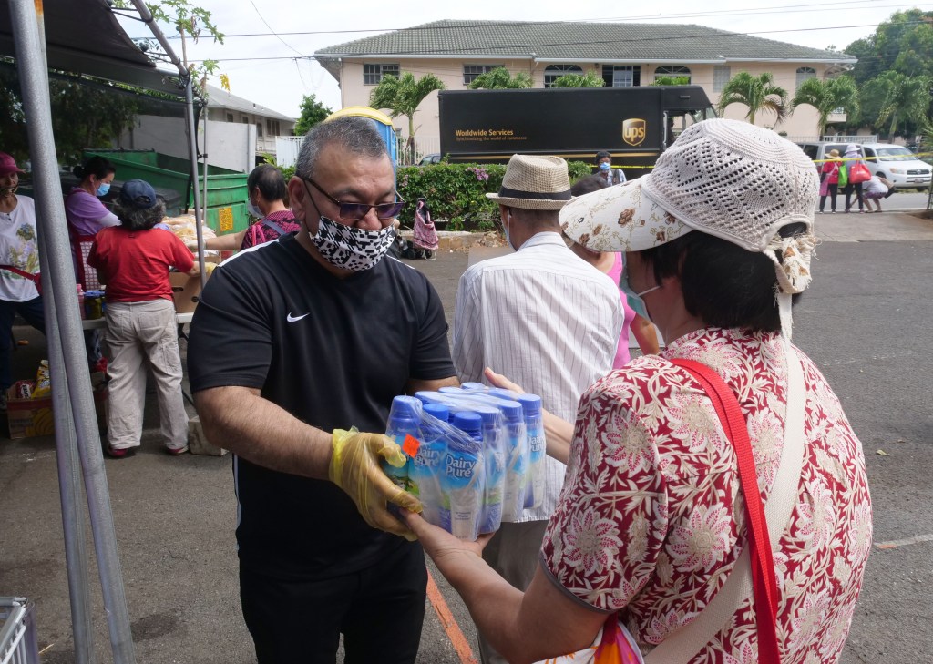 Hawai'i Representative John Mizuno, Chair of the House Health Committee, volunteers to help pass out food donations to homeless and others in need at the Hawai'i Cedar Church in Kalihi, HI, on Monday, June 8, 2020.  (Ronen Zilberman photo Civil Beat)