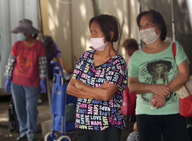 Two women wait for the start of a food donation event for homeless and others in need at the Hawai'i Cedar Church in Kalihi, HI, on Monday, June 8, 2020. (Ronen Zilberman photo Civil Beat)
