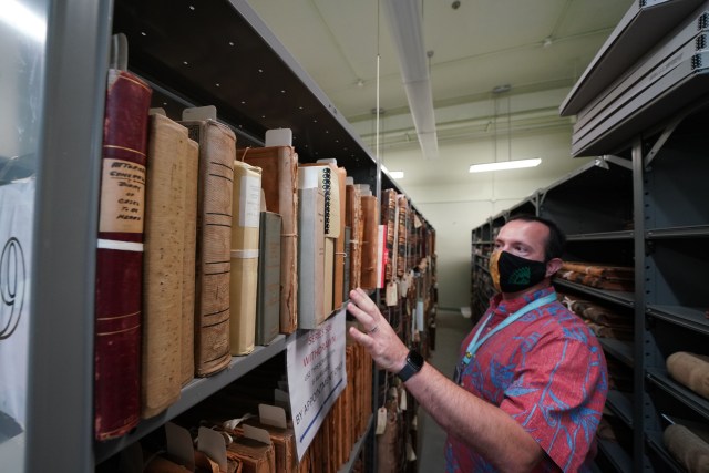 Hawaii State Archivist Adam Jansen show some of the older documents at the State Archives buiding, second floor.