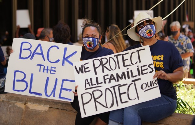 SHOPO supporters Lormona Meredith and right, Jenn Meredith hold signs in SHOPO and HPD support at the Capitol Rotunda. July 6, 2020.