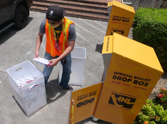 Levi Viloria a City & County of Honolulu election official empties a ballot collection box outside the Honolulu Hale in Honolulu, HI, Saturday, August 8, 2020. (Ronen Zilberman photo Civil Beat)