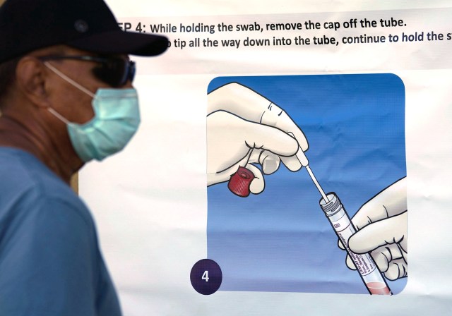 Free COVID-19 testing held at the Kalakaua District Gym. Patients read the posters while standing in line. August 27, 2020