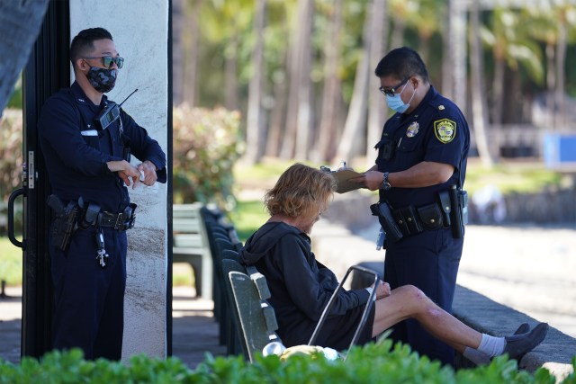 HPD officers hand out citations along Kalakaua avenue due to the Mayor’s order that closed parks and beaches around Oahu due to COVID-19 pandemic. August 12, 2020