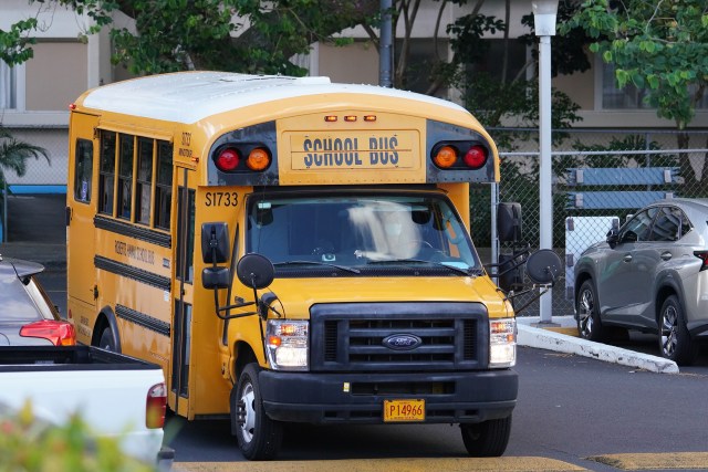 Roberts School Bus travels thru a parking lot to pick up some students. August 17, 2020
