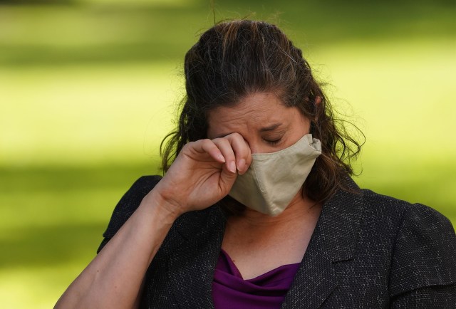 State of Hawaii Dept of Health Epidemiologist Dr. Jennifer Smith, PhD wipes away tears at the press conference with CongresswomanTulsi Gabbard. August 14, 2020