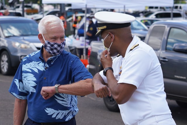 Vice Admiral Jerome Adams, US Surgeon General gives an elbow bump to Mayor Kirk Caldwell at the conclusion of the COVID-19 surge testing press conference held at Leeward Community College parking lot. August 26, 2020