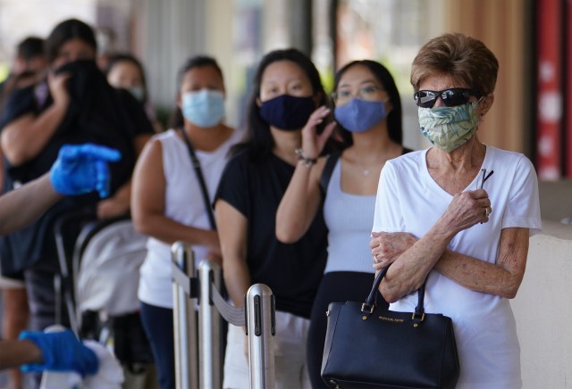 Customers line up socially distanced outside Kahala Whole Foods during COVID-19 pandemic. August 5, 2020