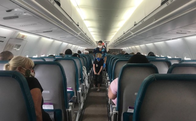 Passengers are socially distanced on a Hawaiian Airlines flight during COVID-19 pandemic.