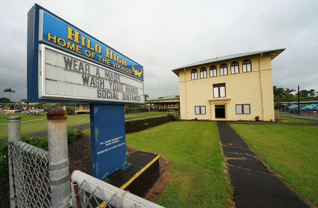 Hilo High School sign fronting the school on the island of Hawaii reminds students to Wear A Mask, Wash your Hands and Social Distance during a surge in COVID-19 cases. September 24, 2020