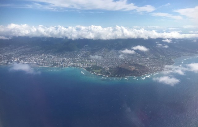 Aerial view of the island of Oahu with Waikiki and Diamond Head on the right of the frame.