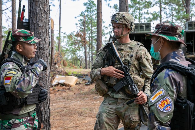 2nd Lt. Johnathan Molnar, a medical officer with C Company, 225th Brigade Support Battalion, 2nd Brigade, 25th Infantry Division, talks about medical operations with Indonesian Army 1st Lt. George Tirtadihatmo, a medical doctor with Headquarters Company, 515th Raider Infantry Battalion, 2nd Infantry Division and Indonesian Army Chief Sgt. Masrul, a combat medic with 3rd Field Medical Company, 2nd Medical Battalion, 2nd Infantry Division during an exercise at the Joint Readiness Training Center at Fort Polk, Louisiana, Oct. 16, 2020. The JRTC exercise is a capstone training event that allows 2nd Brigade to achieve certification for worldwide deployment while building interoperability with key allies in support of a free and open Indo-Pacific. (U.S. Army photo by Sgt. Ezra Camarena, 28th Public Affairs Detachment)