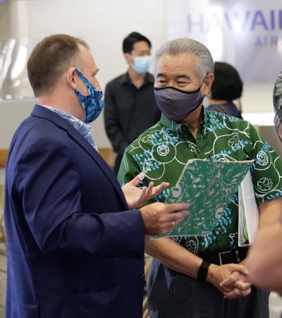 Hawaii Govenor David Ige (right) and Lt. Govenor Josh Green speak together after giving a media briefing Tuesday, Oct. 7, 2020 in Honolulu, HI. The briefing was held to unveil new COVID-19 safety measures the state plans to implement upon re-opening to travelers on October 15th. (Ronen Zilberman photo Civil Beat)