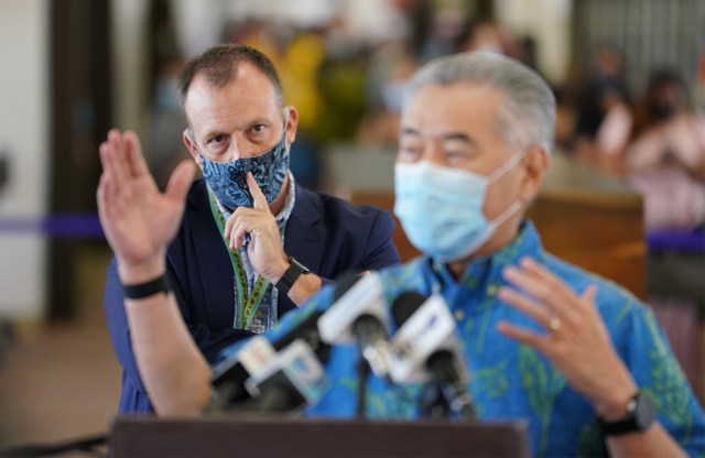 Lieutenant Governor Josh Green looks on with Governor David Ige in foreground, during the first day of lifting of a mandatory 14-day quarantine if arriving transpacific travelers received a negative COVID-19 test prior to arriving to Honolulu at Daniel K. Inouye International Airport during COVID-19 pandemic. October 15, 2020