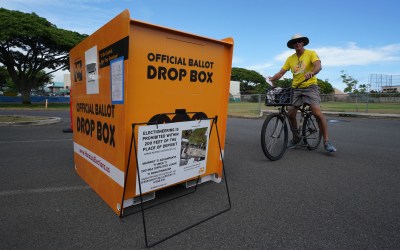 Kailua resident Dale Jensen rides up to drop off his general election ballot at Kailua District Park.