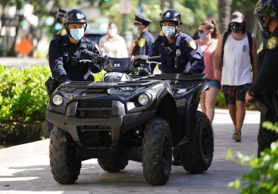 HPD Honolulu Police officers move an ATV Quad/ 4 wheeler outside the Waikiki Substation.