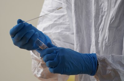 UH Medical School Nurse Practitioner Cris Milne prepares to insert swab into vial during COVID-19 testing held at the Kakaako campus. October 19, 2020