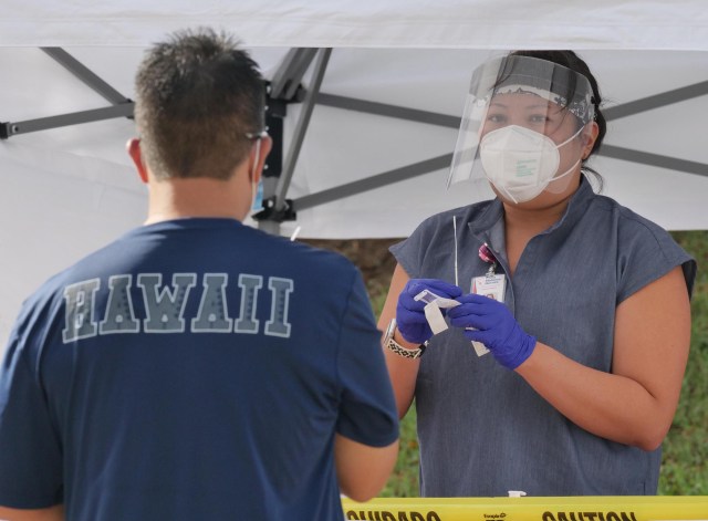 A medical technician demonstrates how to administer a COVID-19 test during a free testing clinic at the Waikiki Shell, in Honolulu, HI, Wednesday, November 11, 2020. (Ronen Zilberman photo Civil Beat)