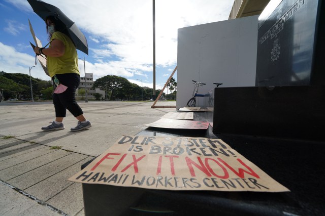 Sign reads ‘DLIR is Broken Fix it now! ‘ at a small demonstration held at the Capitol.