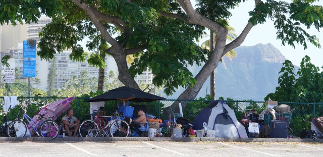 People in tents camp along fence of the Hilton Lagoon in Waikiki during COVID-19 pandemic. November 12, 2020