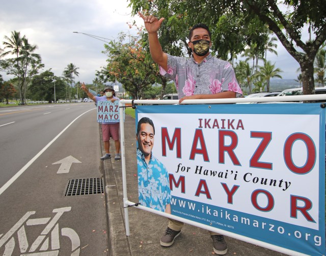 Ikaika Marzo, candidate for Big Island Mayor, sign-waves with supporters along Hilo Bayfront. Photo: Tim Wright