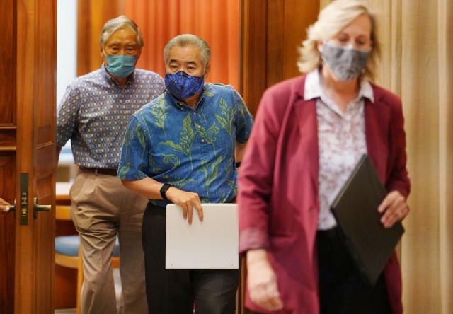 Governor David Ige walks into his ceremonial office before the budget press conference with his team.