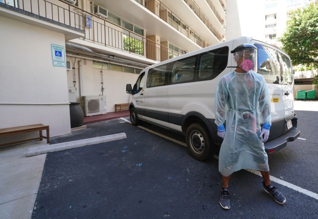 Patient transporter Randy Puootuuo stands in full personal protective equipment outside the van he drives during media tour at the Pearl Hotel Waikiki. September 10, 2020