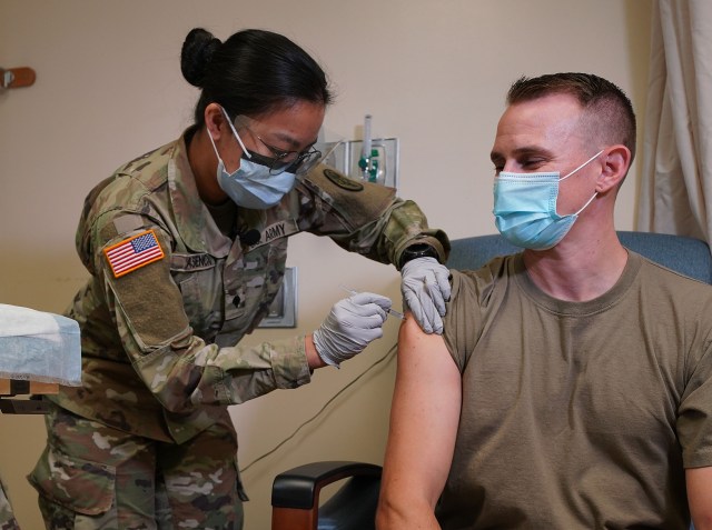 Army Medic Angela Asencio gives Army Captain Jason Tuttle part #1 of Pfizer-BioNTech COVID-19 vaccine at Tripler Army Medical Center. December 17, 2020