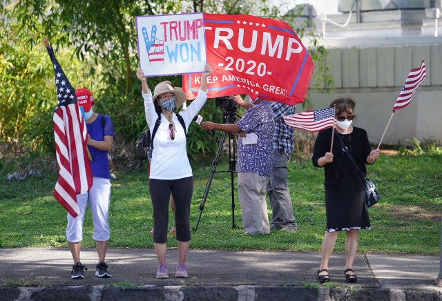 Trump supporters holds signs and flags along King Street, fronting the Capitol. January 6, 2021.