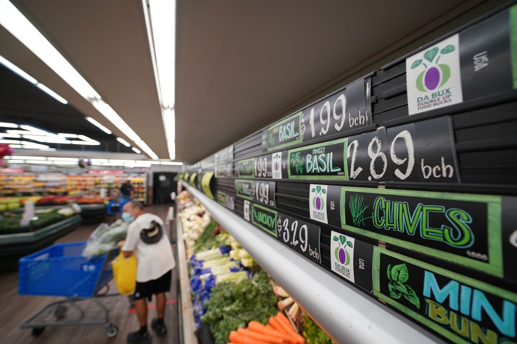 Da Bux signs near the vegetables at Times Supermarket King Street.