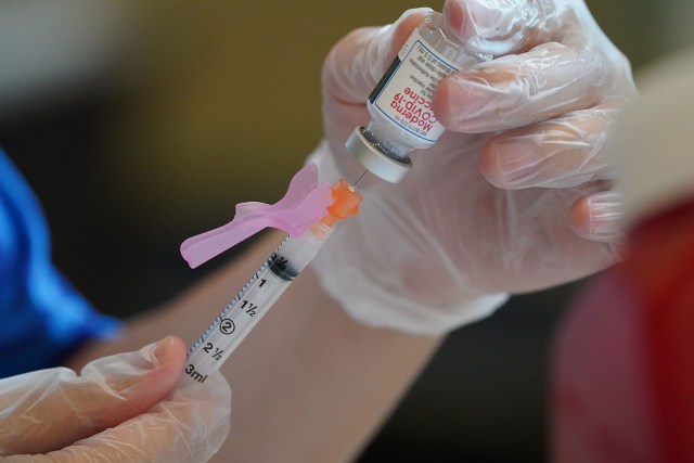 Pharmacist Davis Zheng fill syringe with Moderna COVID19 vaccine at Craigside Place carehome part of the plan to vaccinate the elderly. January 5, 2021.