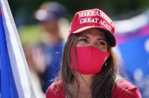 Trump supporter Marissa Delaforce holds a large flag fronting the Capitol today. January 6, 2021