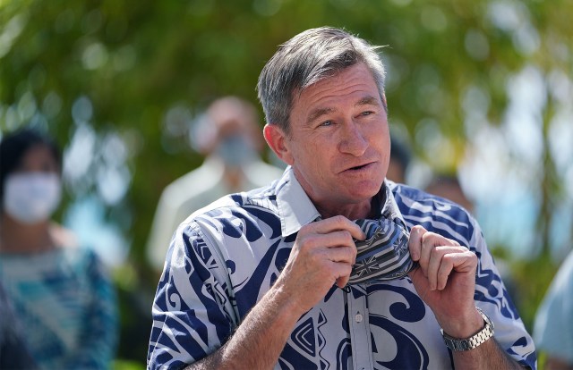 Honolulu City Council member Tommy Waters gestures with mask during Waikiki press conference announcing a new banner being installed along Kalakaua Avenue about COVID-19 safe practices. February 21, 2021