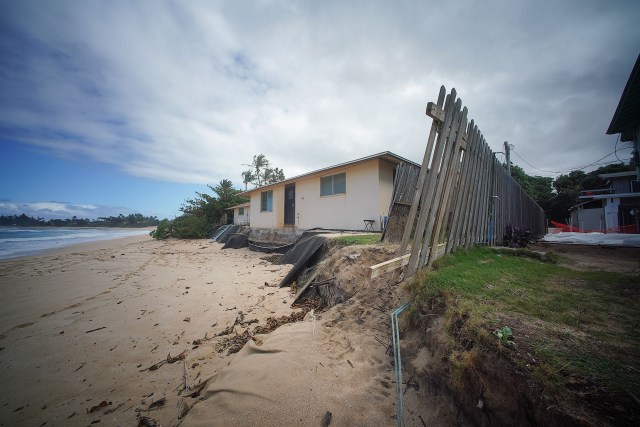 Sunset Beach erosion with a view of a home on Ke Nui Road that the makai side of the property is being inundated and sand and foundations are being washed away by the ocean. February 4, 2021